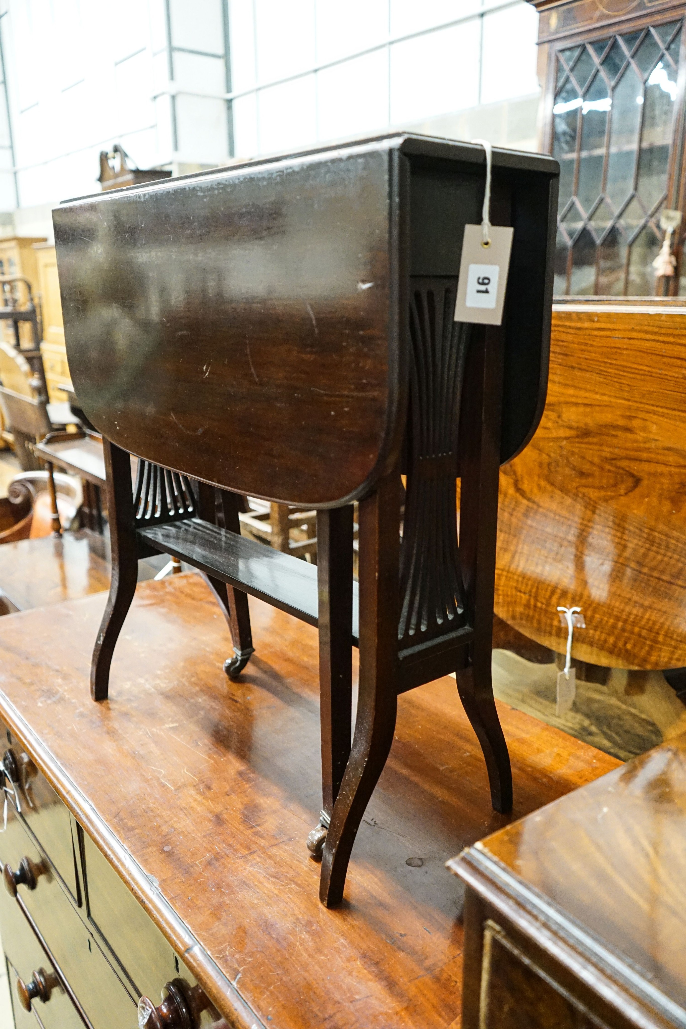 An Edwardian mahogany Sutherland table, width 61cm together with a Queen Anne style figured walnut narrow seven drawer chest